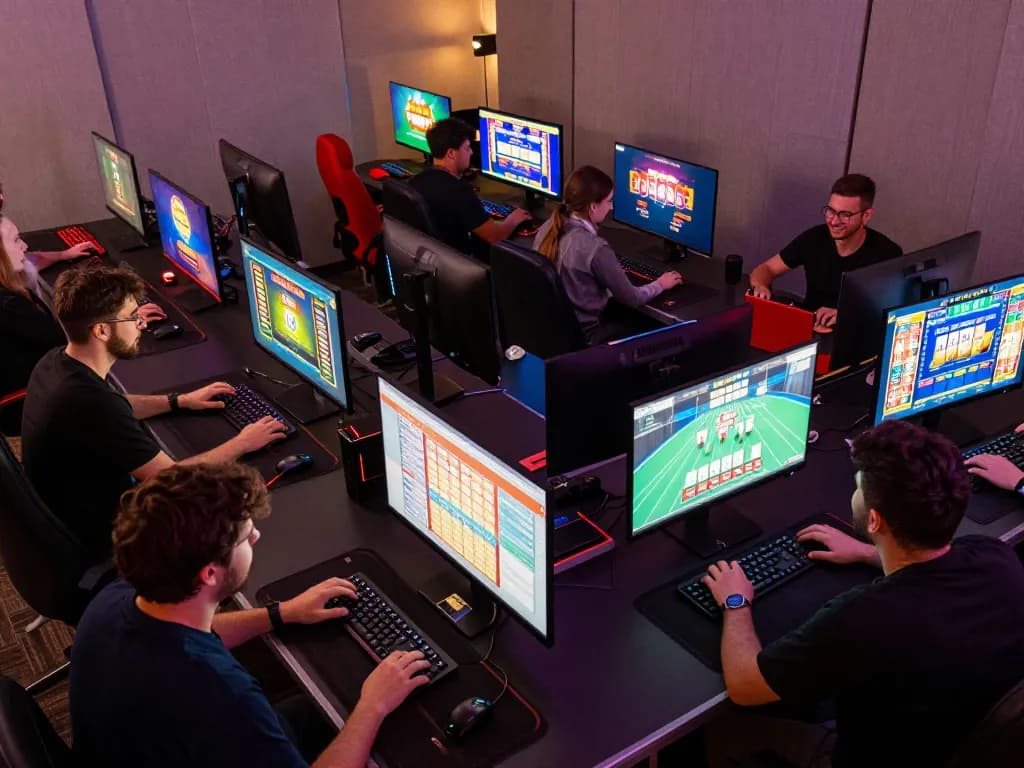 Players enjoying online casino games on their computers, featuring tr88 strategies for better gaming.